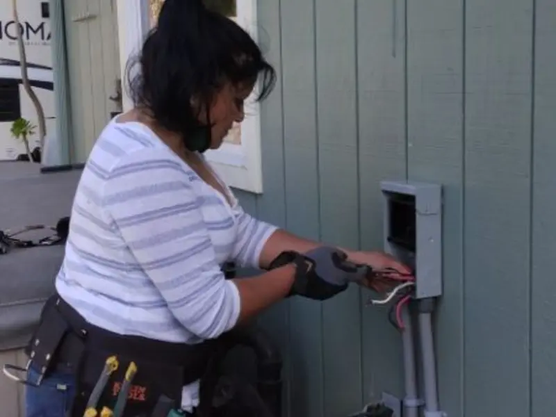 Licensed electrician wiring an exterior subpanel in Wakefield